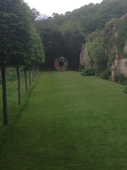 David Harber statue at the end of a grassed walkway at Chilworth Manor