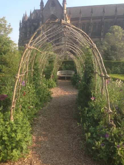 Sweet Pea arch overlooked by the Cathedral Church at Arundel Castle gardens.